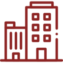 Icon image of two office buildings in red. One building is taller than the other one and has several windows along its side with a wide entrance door. the other building is smaller and has long vertical windows along its side with an entrance door.